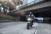 Front angle of a person riding a motorcycle on the freeway.