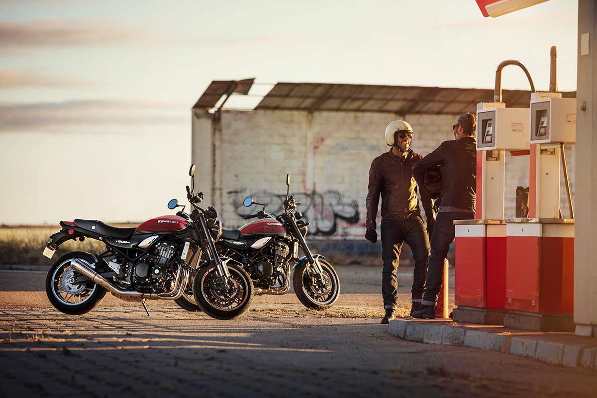 Side angle of two motorcycles at a gas station.