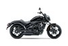 Side angle of a black motorcycle staged in a white studio background.