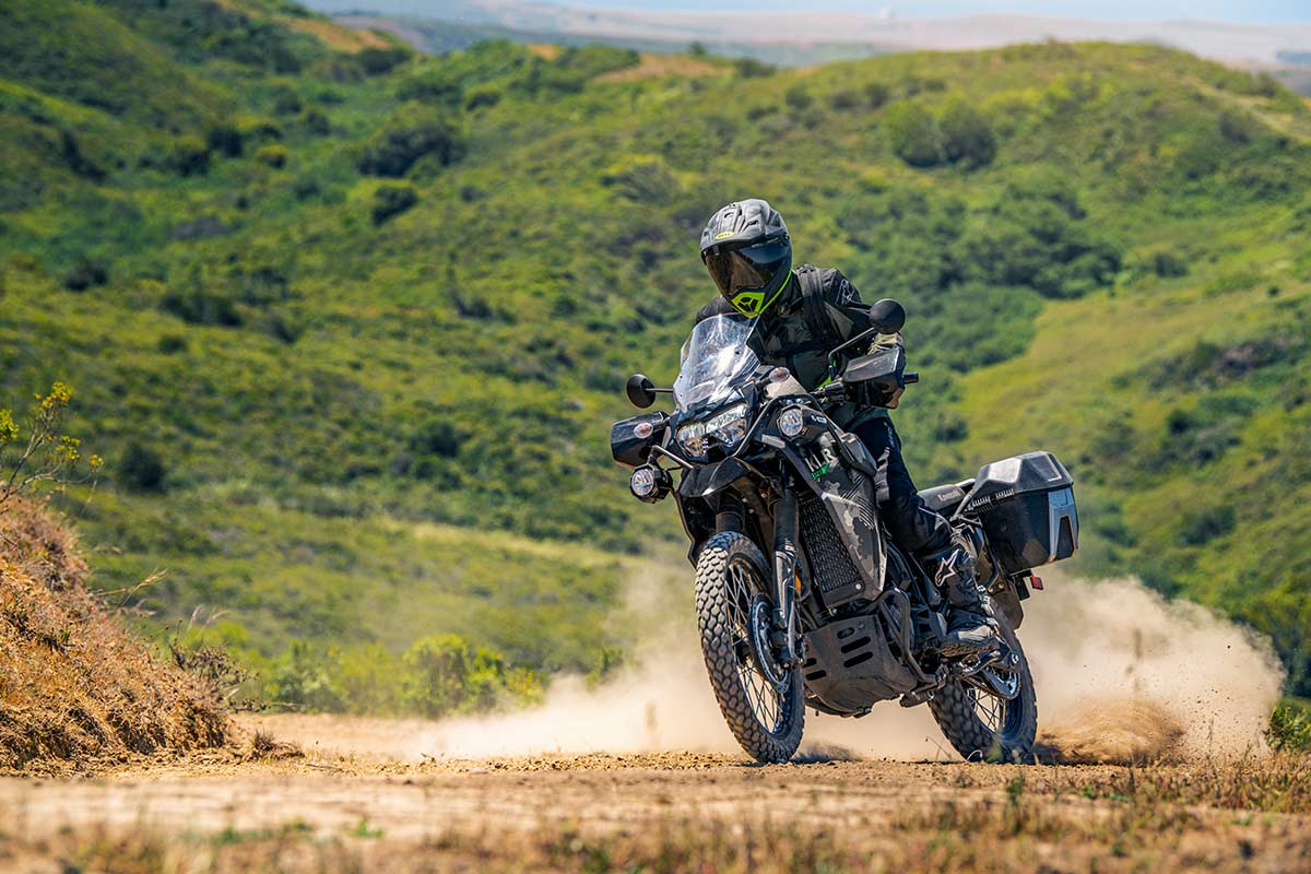 Three-quarter front angle of a person riding a motorcycle off-road.