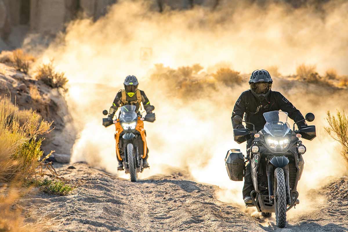 Front angle of two people riding a motorcycle off-road.