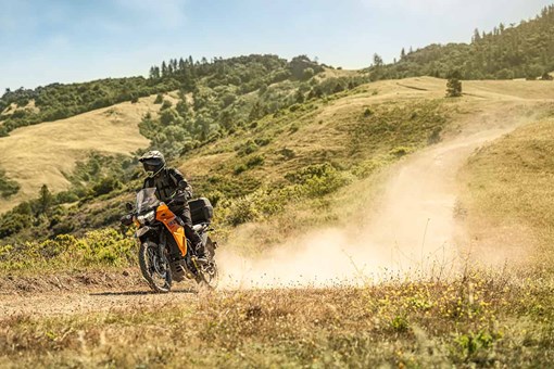 Three-quarter front angle of a person riding a motorcycle off-road. opens in a new window