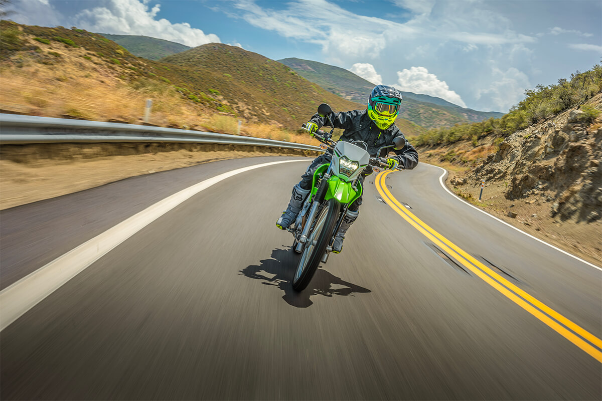 Front angle of a person riding a motorcycle on a highway.