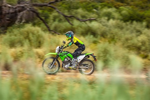 Side angle of a person riding a motorcycle off-road. opens in a new window