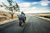 Three-quarter front angle of a motorcycle riding on an open road.