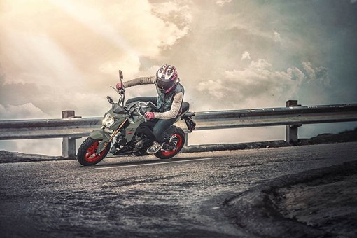 Three-quarter front angle of a person making a sharp turn on a highway. opens in a new window