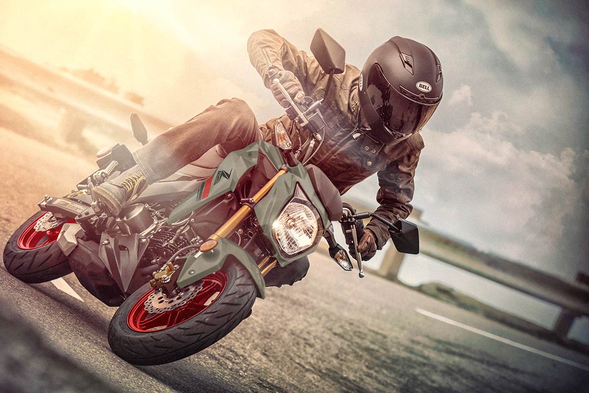 Three-quarter front angle of a person coming out of a turn on a highway.