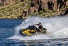 Three-quarter front angle of a person on a personal watercraft on the water.