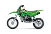 Side angle of a green motorcycle staged in a white studio background.