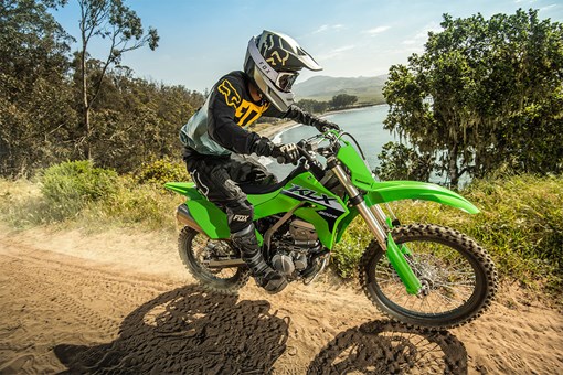 Side angle of a person riding a motorcycle off-road. opens in a new window
