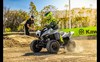 Three-quarter front angle of a child riding an ATV on a track.