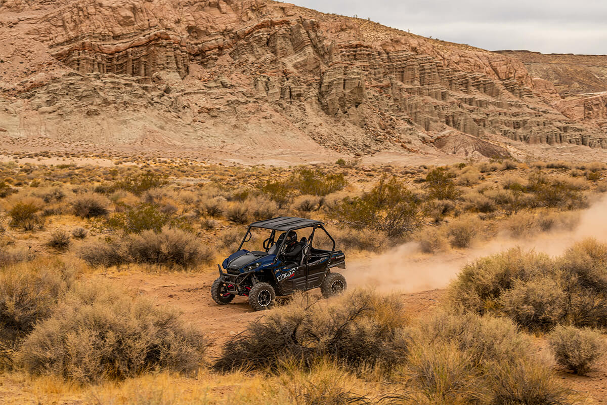 Side angle of a person driving a side x side off-road.