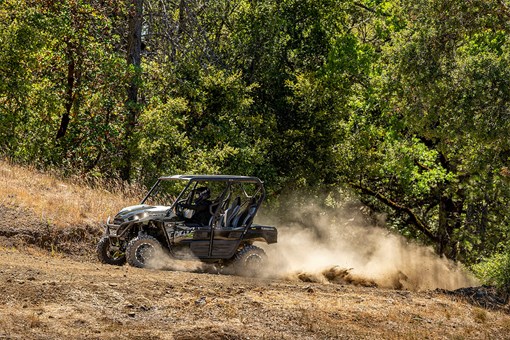 Profile angle of a person driving a side x side off-road. opens in a new window