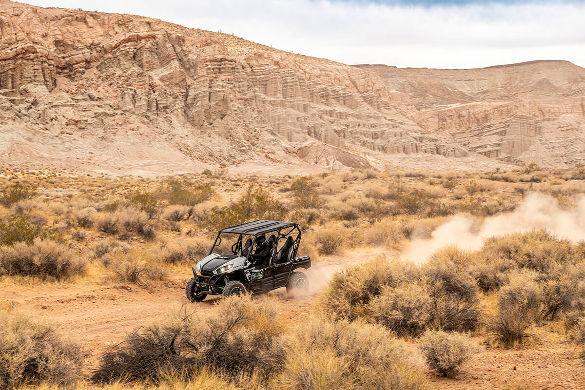 Side angle of a person driving a side x side off-road.