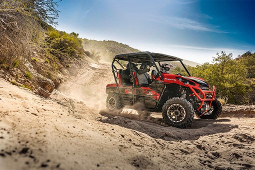 Profile angle of a person and passengers driving a side x side off-road. opens in a new window