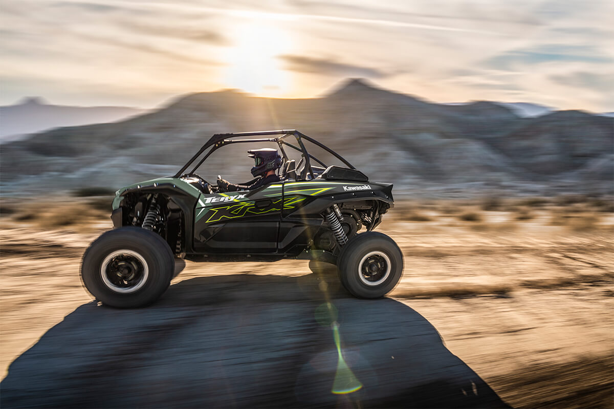 Side angle of a person driving a side x side off-road.