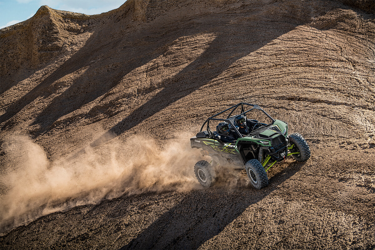 Overhead angle of a person and passenger driving a side x side off-road.