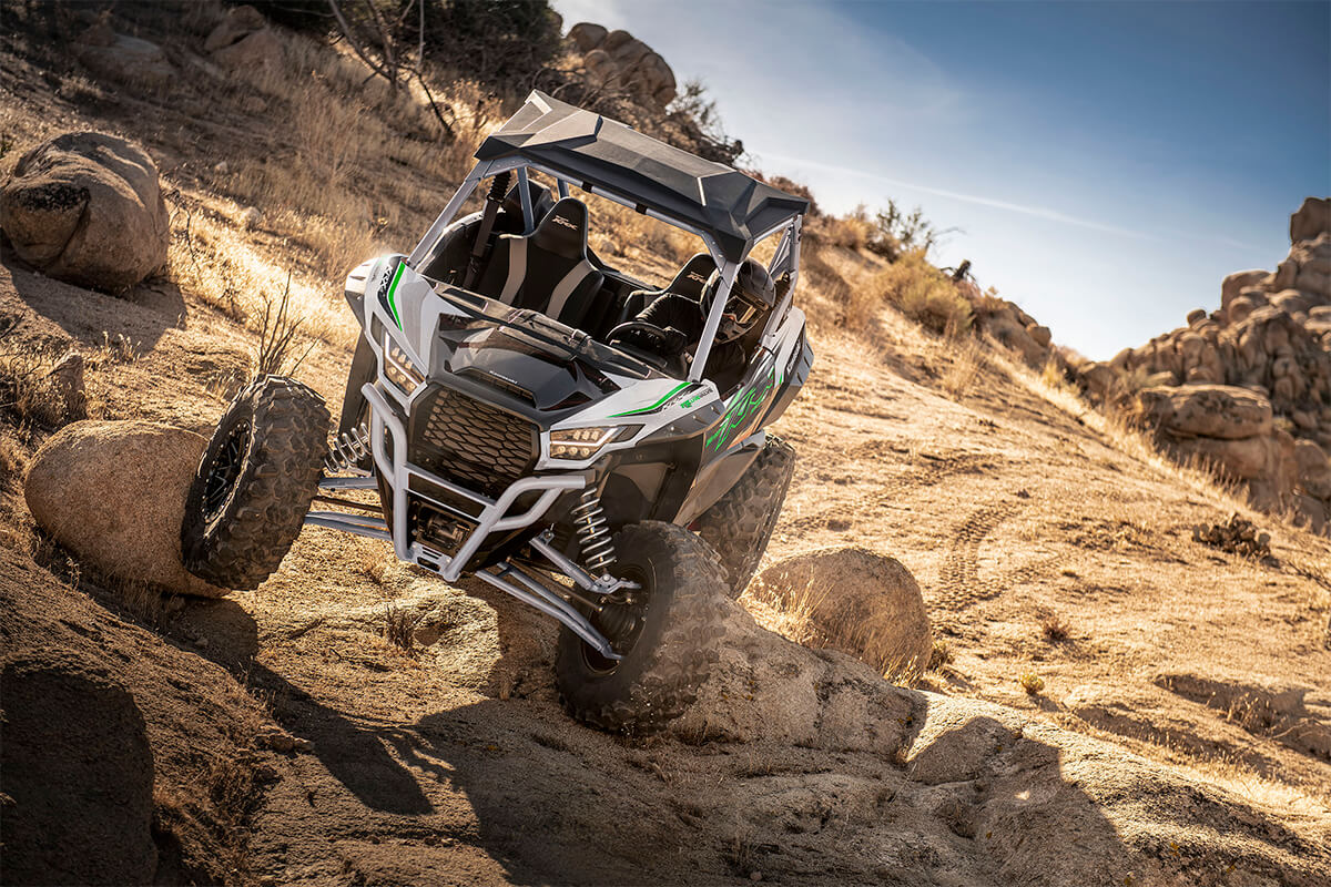 Front angle of a person driving a side x side off-road.