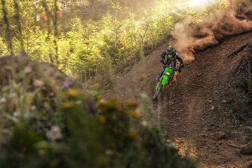 Front angle of a person making a sharp turn on a motorcycle off-road. opens in a new window