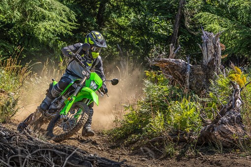 Three-quarter front angle of a person making a turn on a motorcycle off-road. opens in a new window
