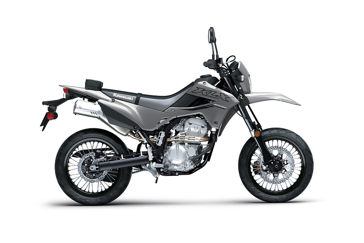 Side angle of a grey motorcycle staged in a white studio background.