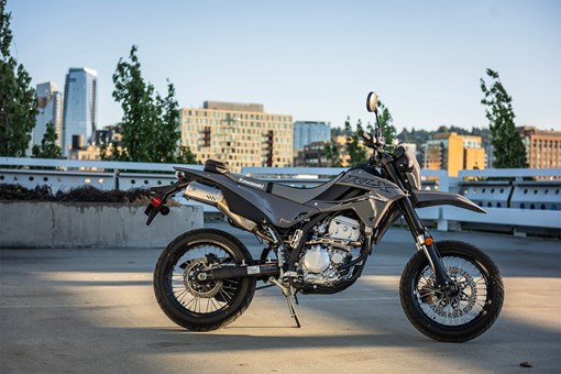 Side angle of a parked motorcycle in a city. opens in a new window