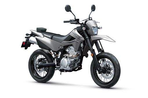 Three-quarter front angle of a grey motorcycle staged in a white studio background. opens in a new window