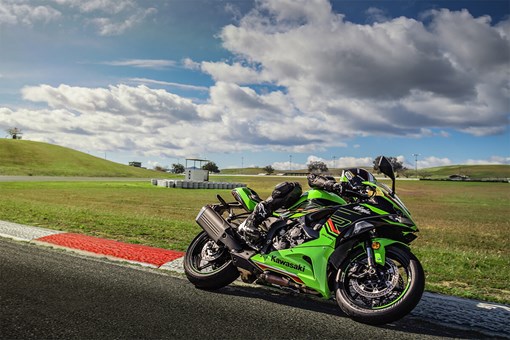 Profile angle of a person on a motorcycle turning on a track. opens in a new window