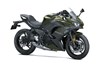 Three-quarter front angle of a dark green motorcycle staged in a white studio background.