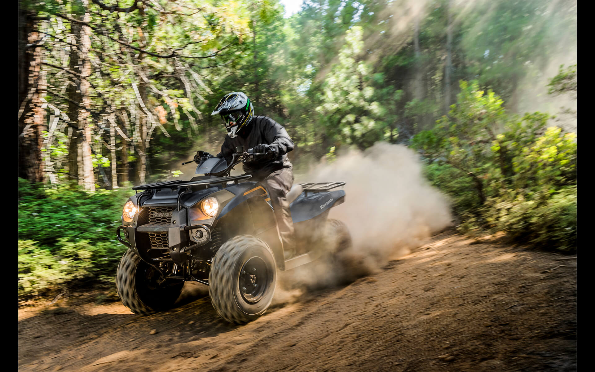 Profile angle of a person riding an ATV off-road.