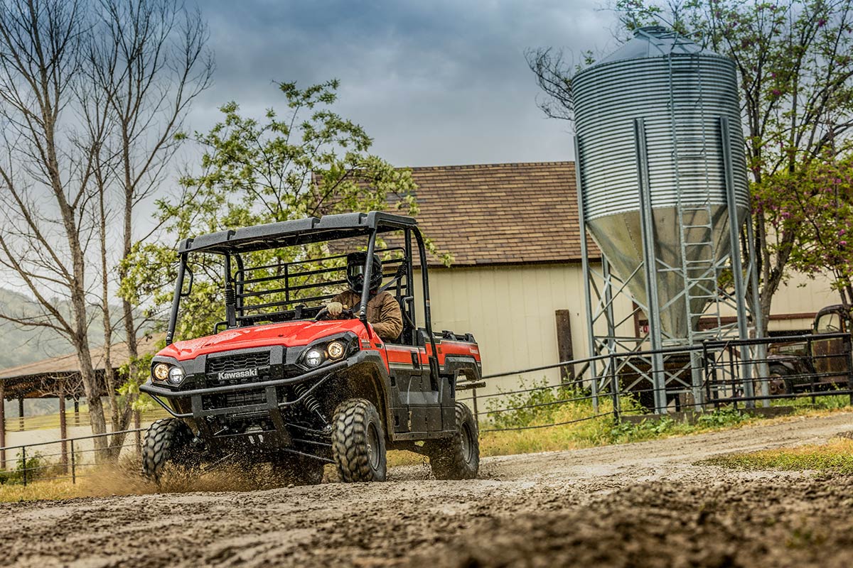 Three-quarter front angle of a person driving a side x side off-road.