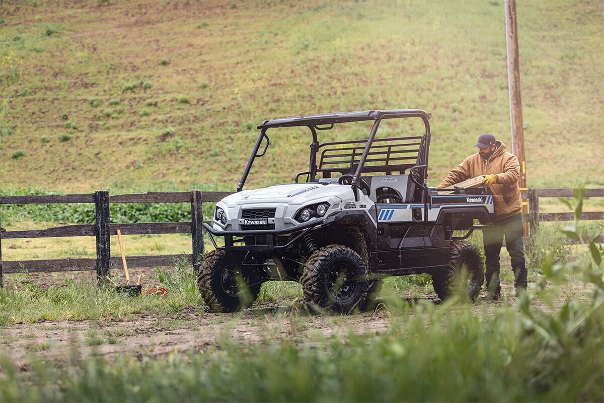Three-quarter front angle of a person unloading a side x side off-road.