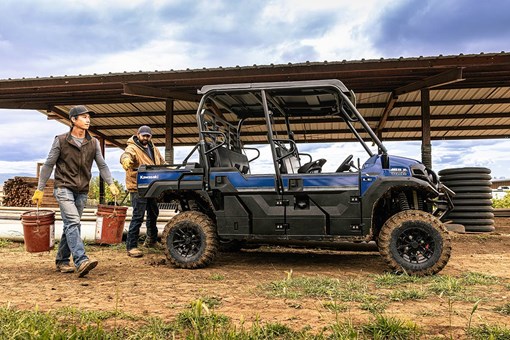 Side angle of two people unloading a side x side off-road. opens in a new window