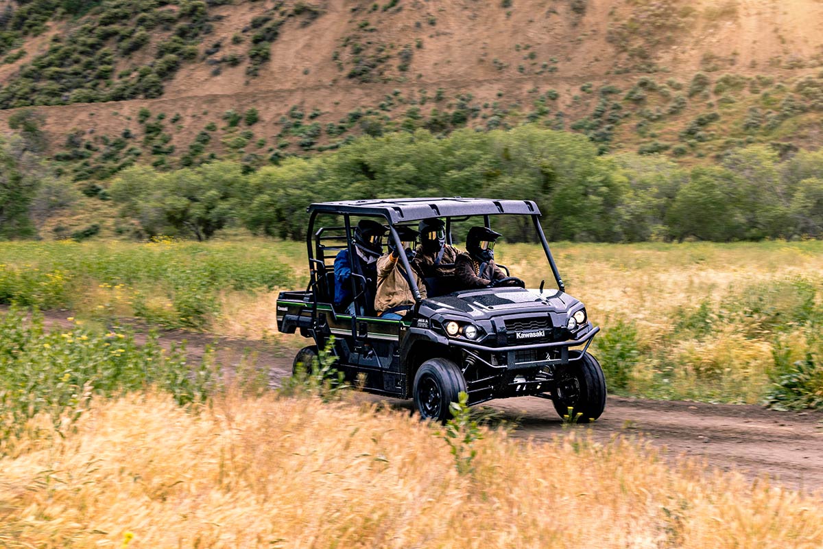 Three-quarter front angle of a person driving a side x side off-road.