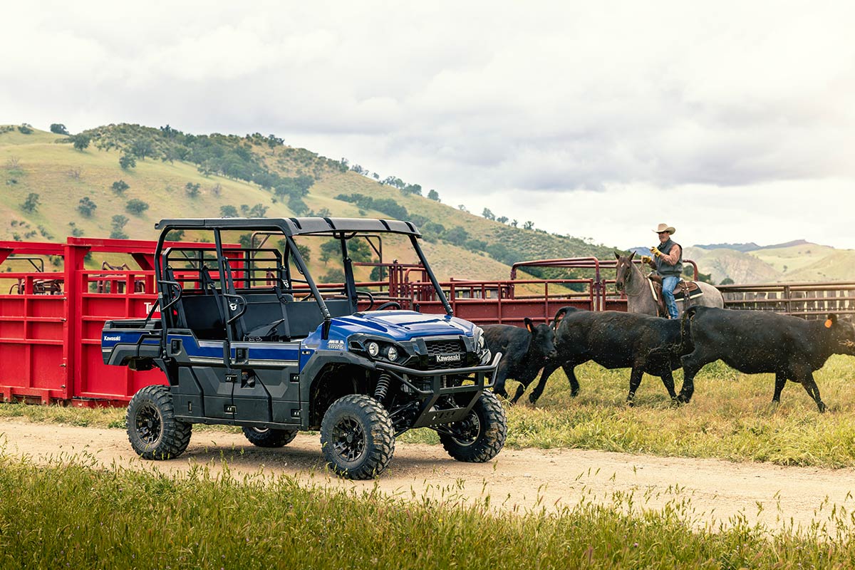 Three-quarter front angle of a parked side x side on a dirt trail.