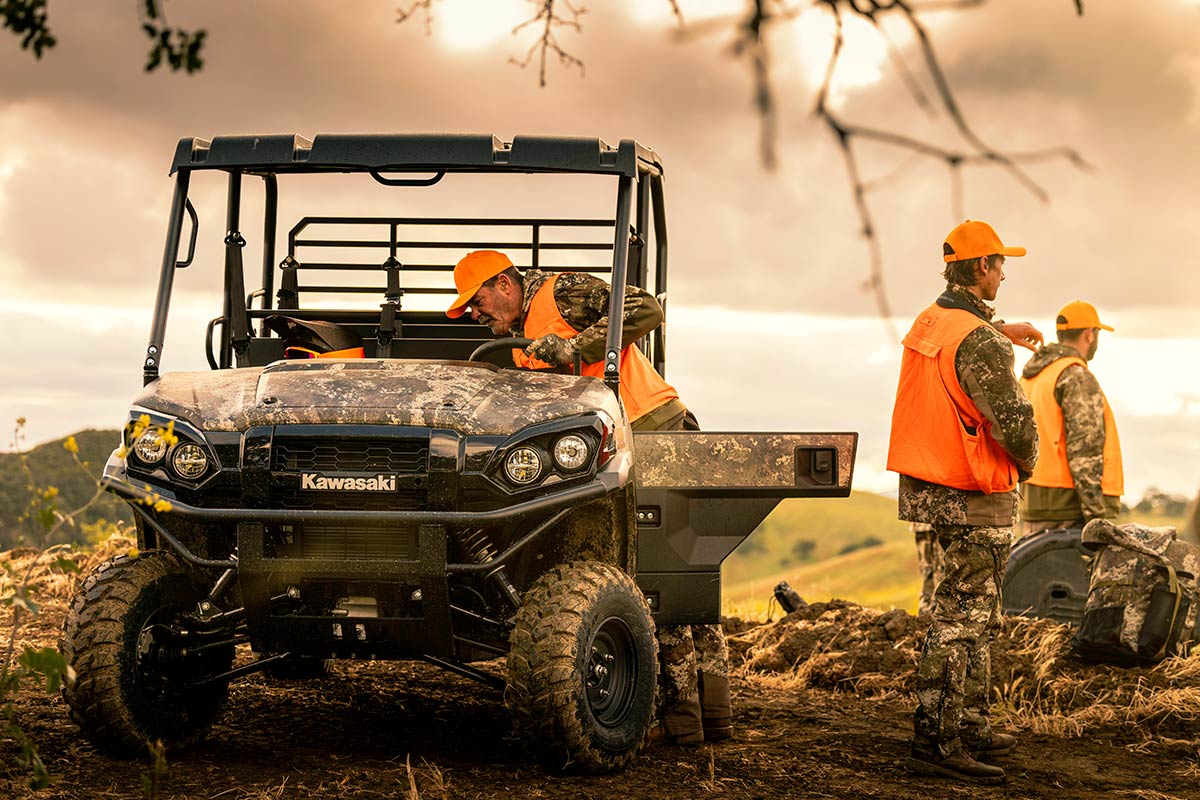 Front angle of a side x side parked off-road with the door open.