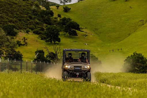 Front angle of a person driving a side x side off-road. opens in a new window