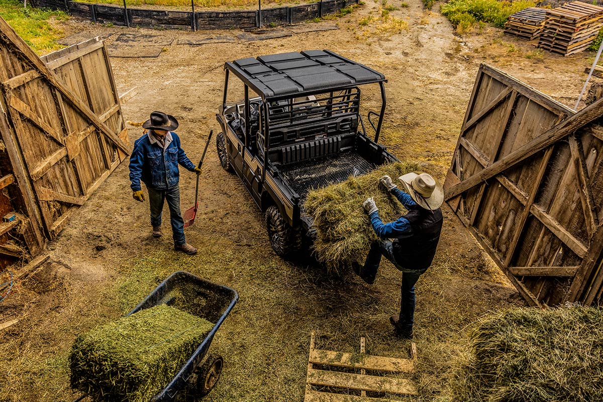 Aerial view of a side x side being loaded next to a barn.