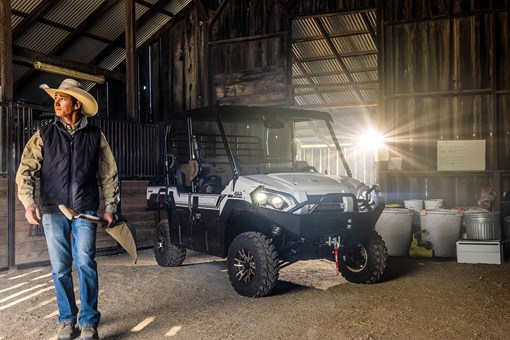 Three-quarter front angle of a side x side parked in a barn. opens in a new window