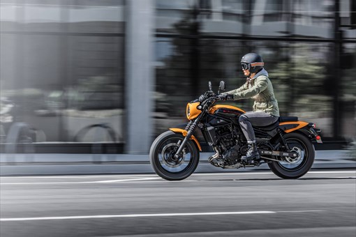 Side angle of a person riding a motorcycle in the city. opens in a new window