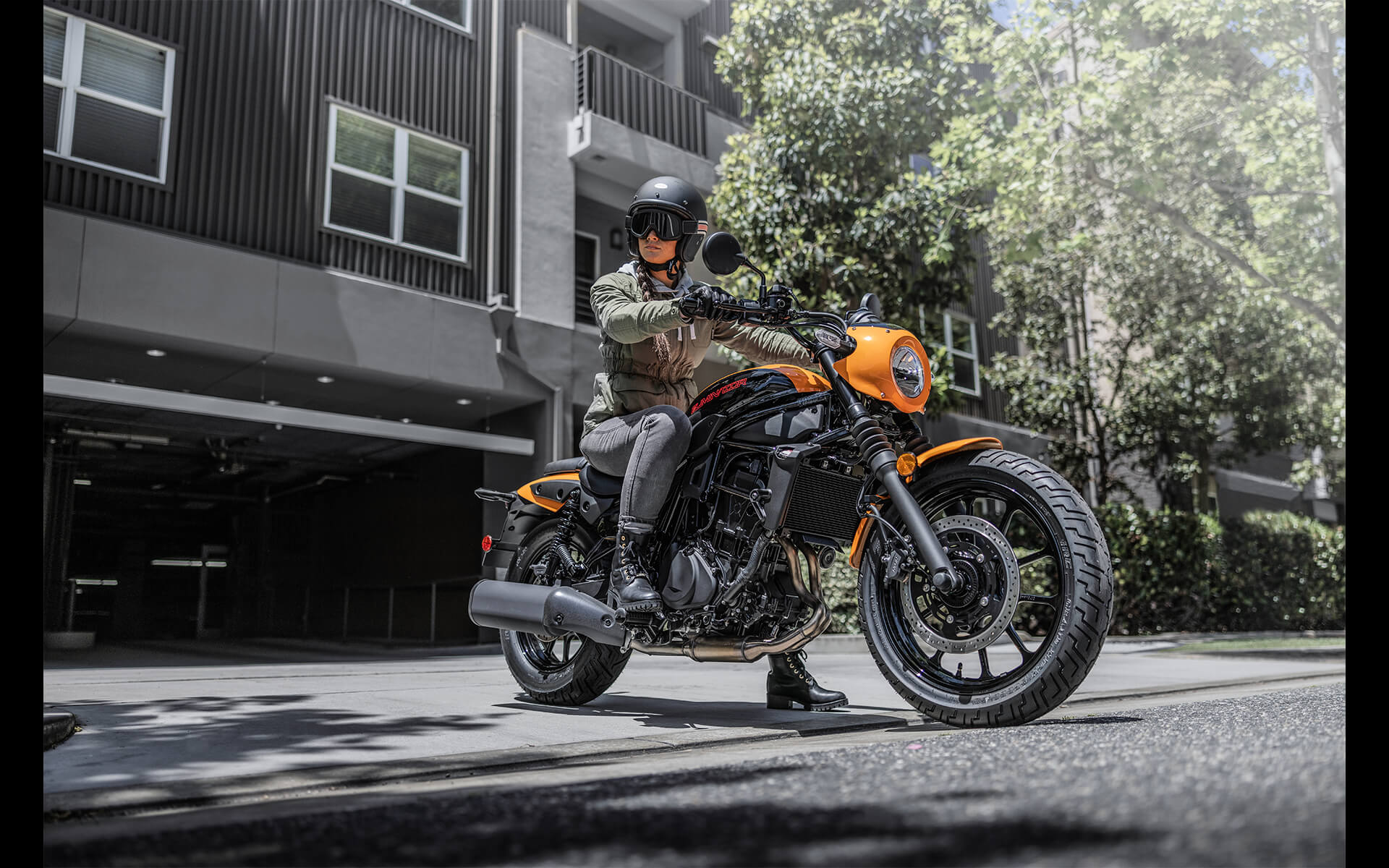 Side angle of a person parked on a motorcycle.