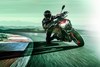 Front angle of a person riding a motorcycle on a racetrack.