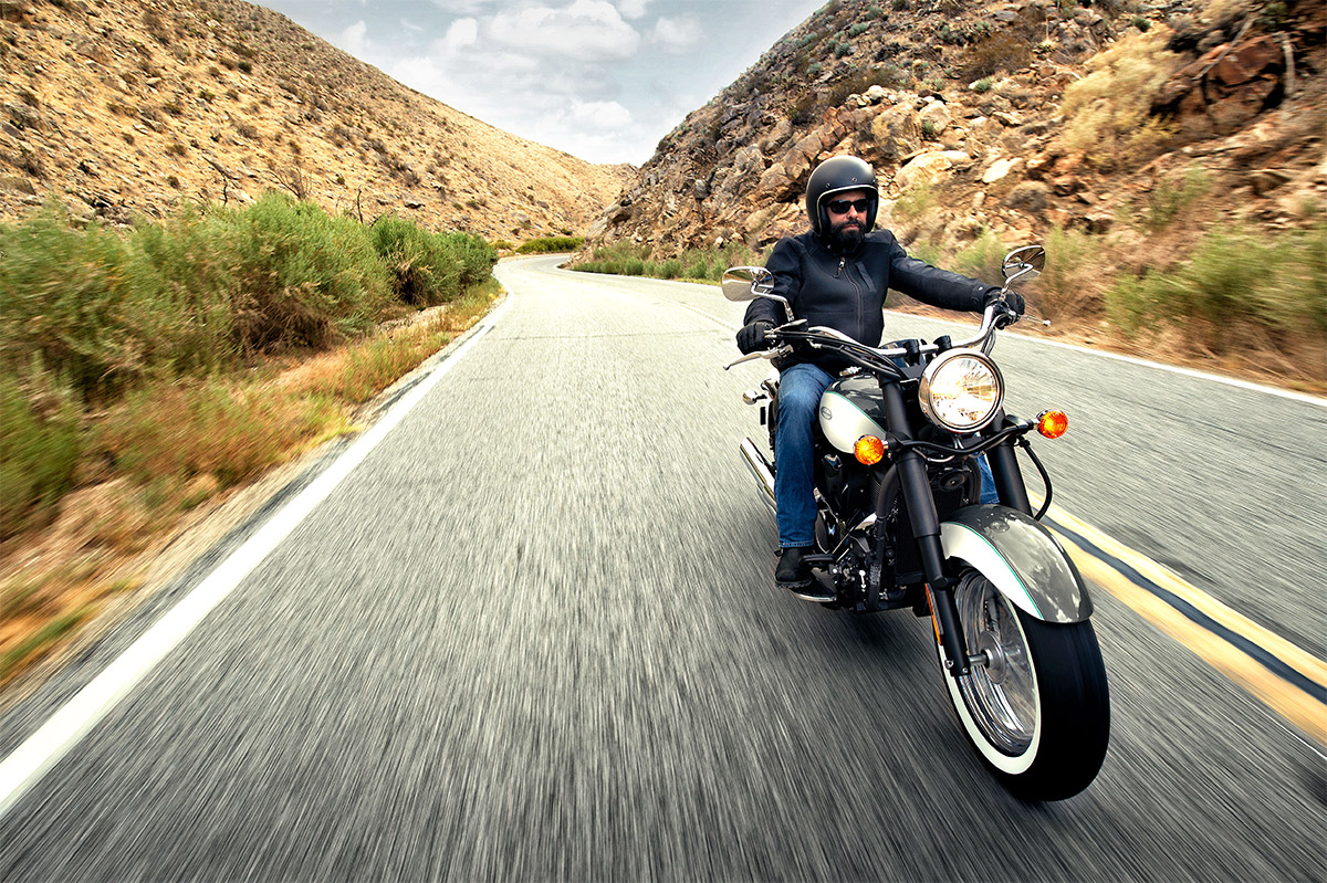 Front angle of a person riding a motorcycle on a road.