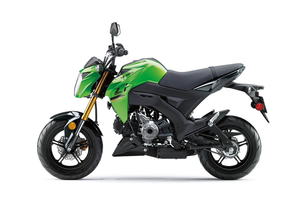 Profile angle of a green motorcycle staged in a white studio background.