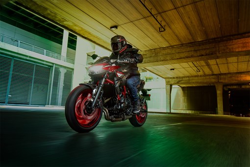 Three-quarter front angle of a person riding a motorcycle in a garage. opens in a new window