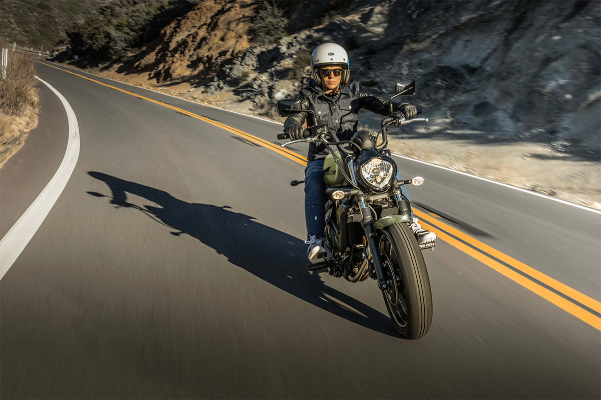 Front angle of a person riding a motorcycle on a road.