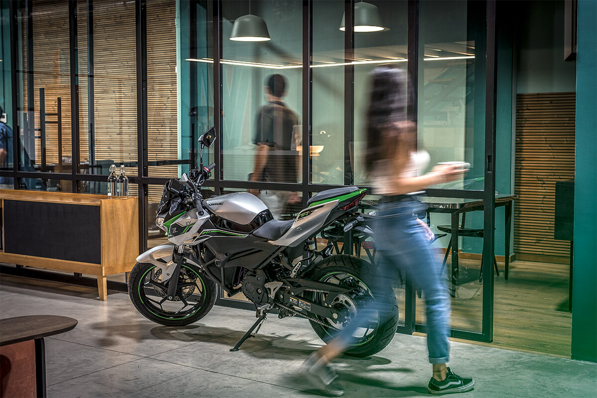 Side angle of motorcycle staged in an office building.