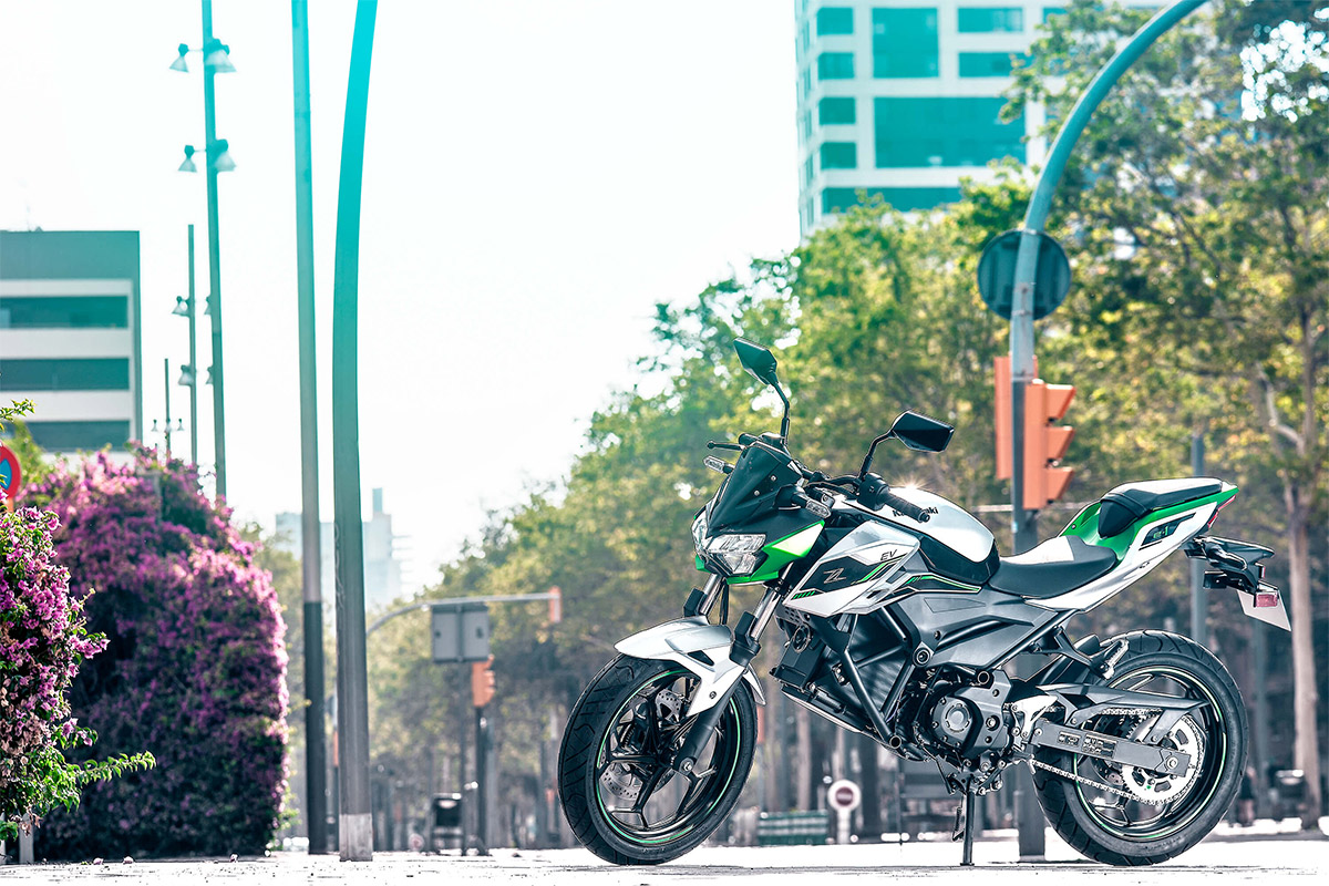 Side angle of a motorcycle staged on a sidewalk.