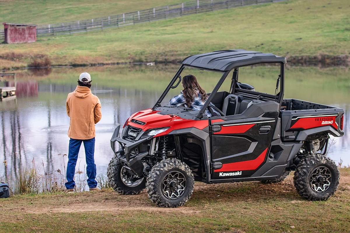 Side angle of a side x side parked next to a pond.