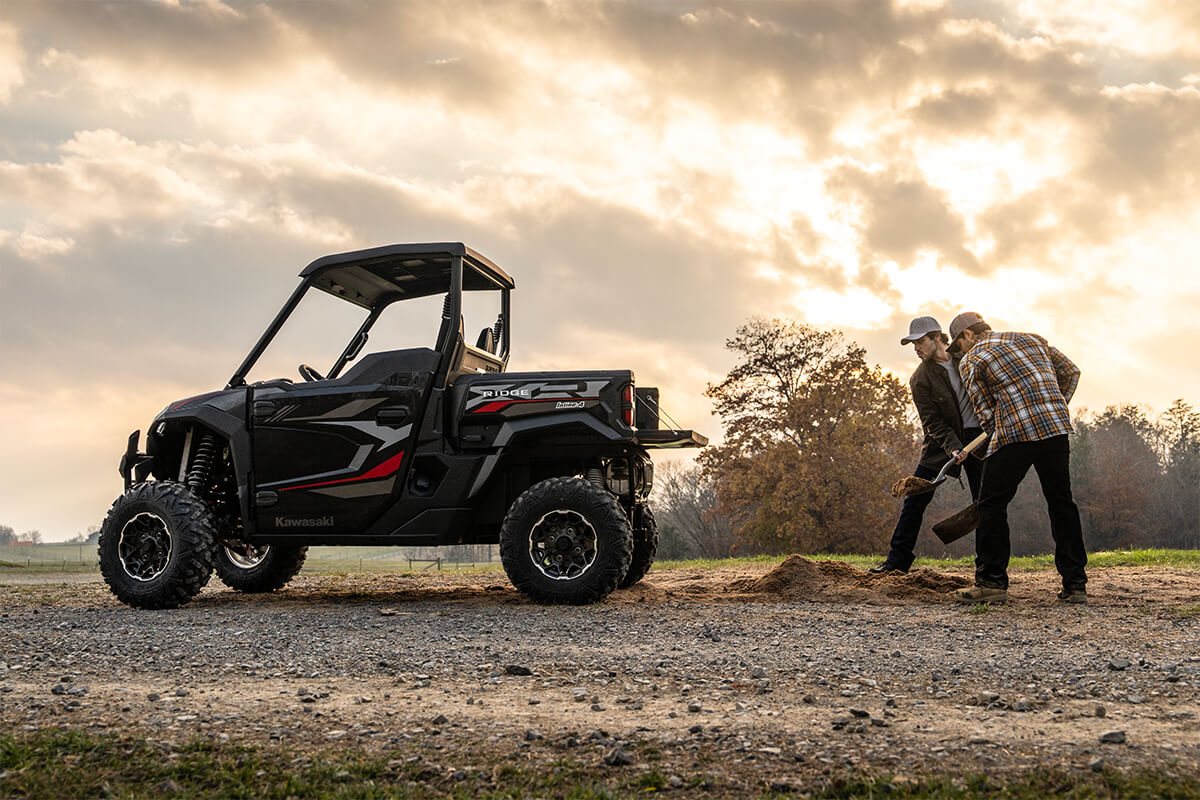 Side angle of a side x side parked near a trail.